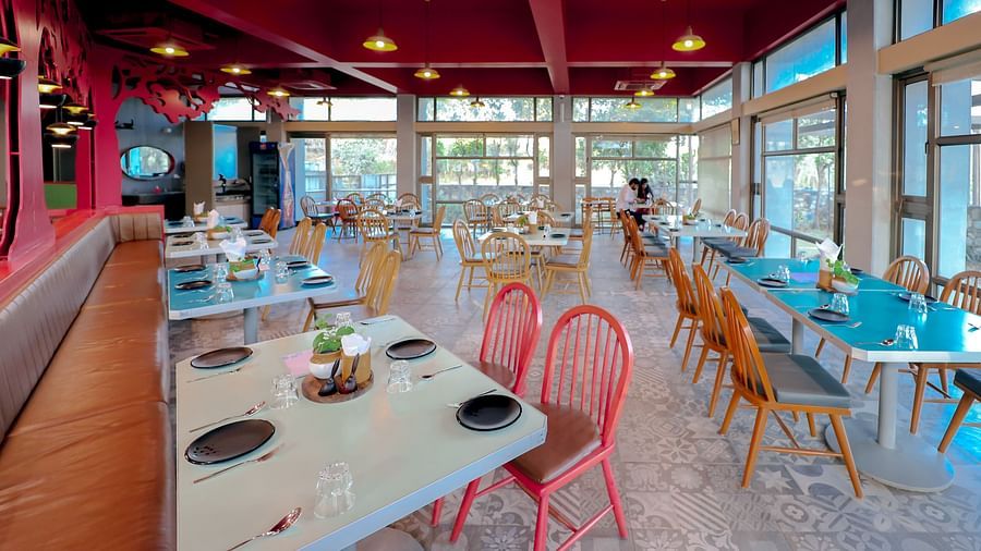 An image of a restaurant featuring chairs and tables at Pride Resort Sambaji